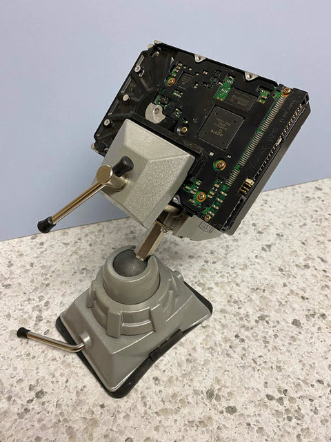 Vacuum Base Vise BV VB With Silver Finish holding electronic component on countertop, showcasing 360° swiveling head and stability