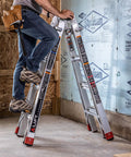 Aluminum 5-in-1 Step Ladder With 18-Foot Reach, Adjustable Multi-Position Frame, Heavy-Duty Extendable Ladder For Home, Garage, Kitchen And Office, Portable Lightweight Workhorse, ANSI Type 1AA, 375 Lb Capacity, Indoor Outdoor. Worker on open step ladder in construction area.