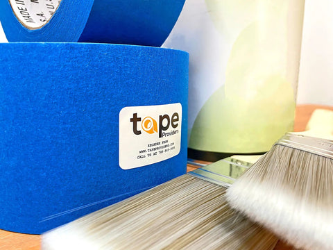 Blue Painter's Tape 2 Inch by 60 Yards Six Pack High-Performance Masking Tape with paintbrushes and jars for wall prep.