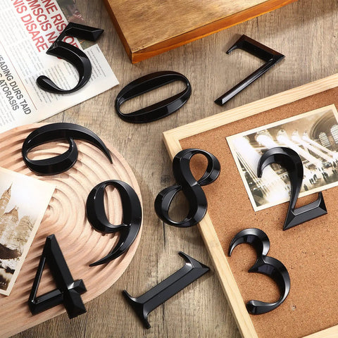 10 Pack Self Adhesive House Numbers 0 To 9 Black 4 By 2.5 Inch No Fuss Easy Peel And Stick Durable Vinyl For Mailboxes Doors Apartments Offices Hotels And Street Address Signs displayed on wooden surfaces with photo frames and newspaper.
