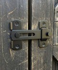 Barn Door Lock Set With Sliding Door Hardware In Carbon Steel Black Finish installed on a wooden barn door