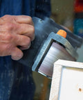 Go-To Corded Belt Sander With Dust Bag, 7 Amp Motor, 3 Inch By 21 Inch Belt in use on wooden surface, close-up view