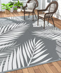 Waterproof Outdoor Rug 5x8 Feet Double-Sided Palm Leaf Pattern Grey And White Plastic Patio Mat on deck with chairs