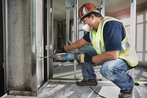 Worker using Workhorse SDS-Plus Bulldog Rotary Hammer Bit 1/4 Inch by 6 Inch with two cutter head on concrete wall.