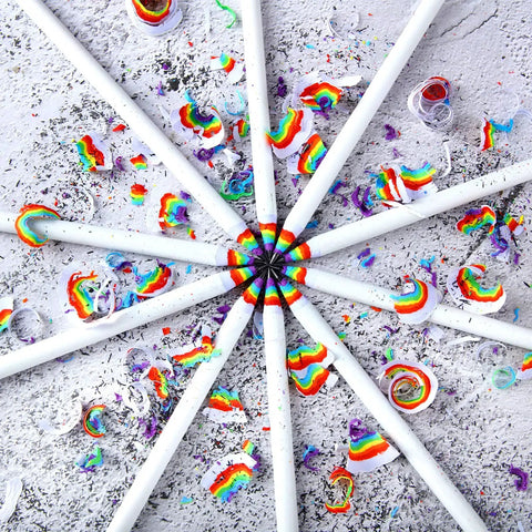 Rainbow Paper Pencils Set 24 Pieces Number 2 HB Graphite Pencils With White Barrels arranged in a circular pattern with shavings.