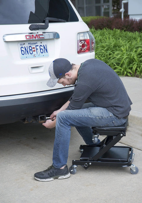 Pro Lift C-9100 Black 40 Inch Foldable Hydraulic Repair Creeper With Padded Seat and Headers in use under a vehicle.