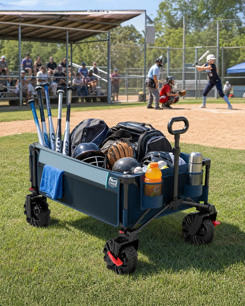 Beast Wagon 600L Folding Utility Wagon With Extra Wide 26 Inch Wheels loaded with sports gear at a baseball field.