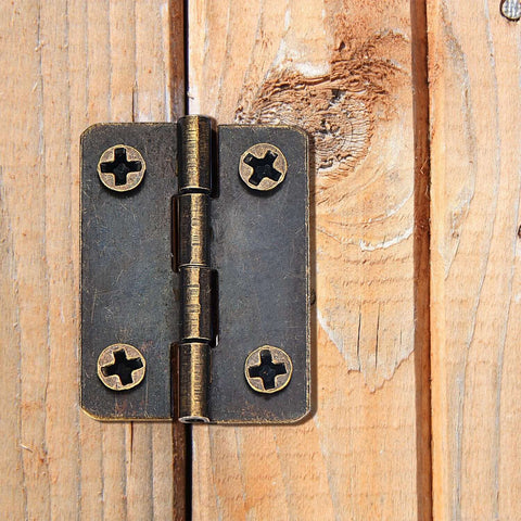 Two Size Bronze Mini Hinge Set With 60 Small Hinges And 300 7 Mm Screws In Clear Storage Box for Dollhouse Doors Cabinets Crafts Wooden Jewelry Boxes and Outdoor Decor Totally DIY Ready installed on wood surface.