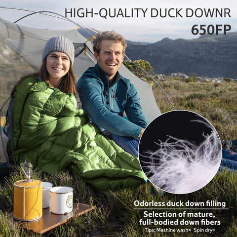 Two adults in a tent with a green Ultralight RDS Down Sleeping Bag for Adults, 650 Fill Power, 42 to 52F Comfort Range.