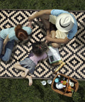 Family enjoying picnic on Waterproof Outdoor Rug 5x8 Ft Reversible Plastic Area Rug For Patio Deck Backyard RV Beach Camping Black And Beige
