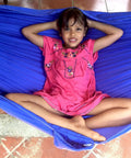 Child relaxing in blue Kid Friendly Camping Hammock For Indoors And Outdoors, Ultra Comfy Hangout Hammock For Kids, on tiled floor.