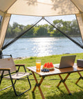 12 X 12 Ft Camping Screen Tent For 8 To 10 People, Easy Setup Mosquito Net Canopy, beige interior with picnic setup by river