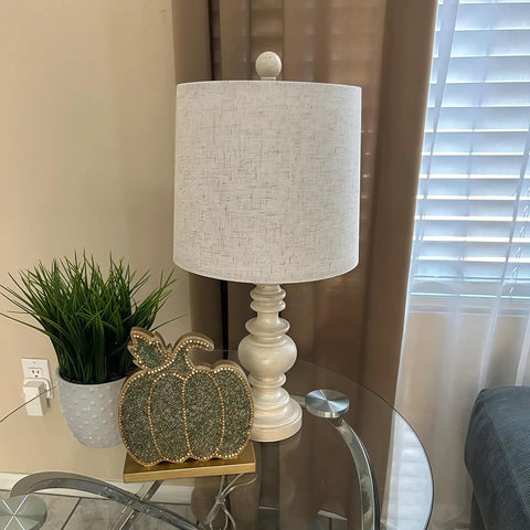 Super Cool Rustic Table Lamp Set Of Two With Vintage Farmhouse Vibes shown on nightstand, antique white resin base, linen shade.