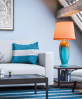 Colorful living room with blue and orange globe lamp on side table