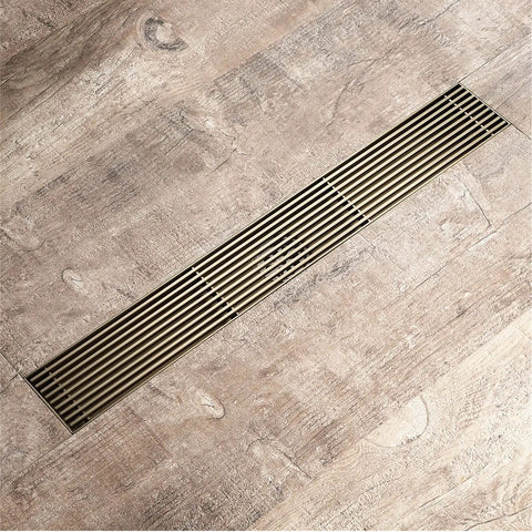 Top Shelf Game Changer Stainless Steel Rectangle Floor Drain Cover With Removable Grate Hair Catcher Filter For Bathroom Shower on wood floor.