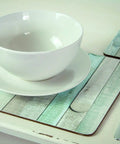 Beach Wood Self Adhesive Film under white bowl and cutlery, showing versatile use on tables and surfaces.