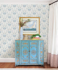 Living room with Blue Shellby Peel And Stick Wallpaper With Coastal Crab Damask Print, vintage cabinet, and framed art