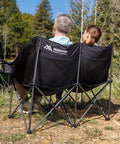 Two Person Oversized Camping Chair Loveseat For Adults Heavy Duty Folding Outdoor Couch Black Portable Patio Lawn Chair Great For Campsites Backyards And Decks Cozy Two Seat Camp Sofa with couple outdoors