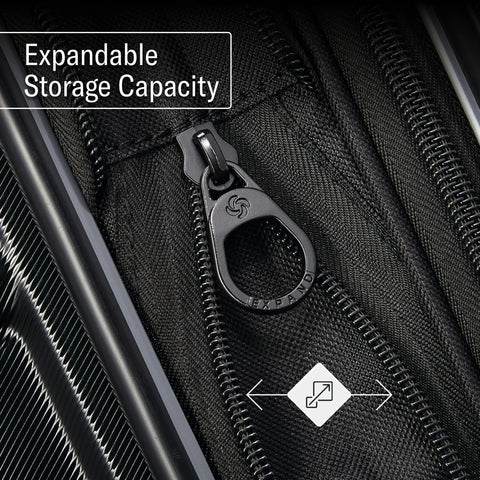 Close-up view of black Samsonite Omni 2 luggage zipper on fabric, expandable storage feature