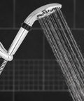 Five Spray Modes Handheld Shower Head With Five Foot Hose Chrome Finish Easy DIY Install Adjustable Bracket Quick Switch On The Fly For Spa Like Clean shown in use with water spray visible.