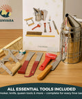 Beekeeping Starter Kit with smoke tool, hive essentials, bee smoker, hive tools, frames, gloves, Apiguard on table.
