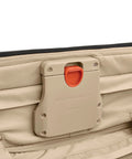 Briggs & Riley luggage latch on tan softside suitcase with orange CX Technology release