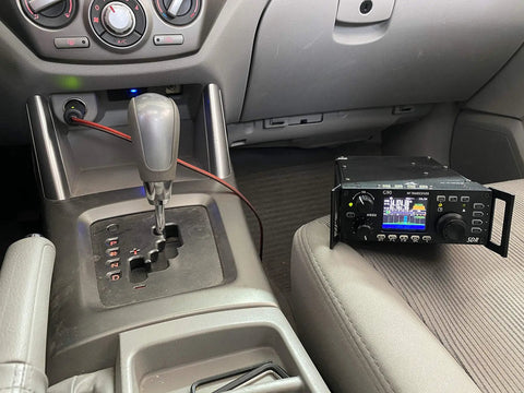 Car Auxiliary 12V Power Plug Adapter Cable for Ham Radio with Mini Tamiya Connector, shown plugged into vehicle 12V outlet.