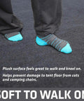 Soft Plush Tent Carpet Mat With Waterproof Backing Keeps You Warm And Dry Inside The Tent shown with feet on charcoal mat