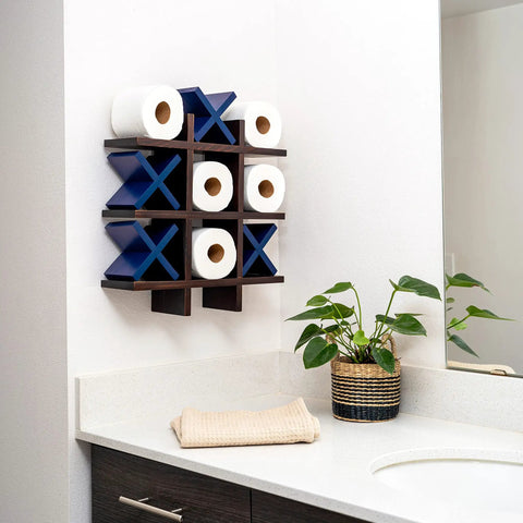 Tic Tac Toe Toilet Paper Holder Dope Wall Mounted Storage displaying toilet paper rolls and blue X's in modern bathroom decor