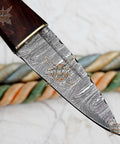 Close-up of Damascus Steel Fixed Blade Camping Knife With Walnut Wood Handle Brass Bolster And Leather Sheath Included