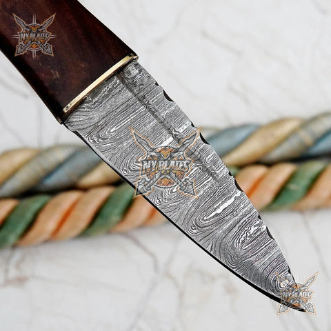 Close-up of Damascus Steel Fixed Blade Camping Knife With Walnut Wood Handle Brass Bolster And Leather Sheath Included