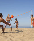 People playing volleyball with Go To Backyard Volleyball Kit For Ultimate Family Fun Easy Setup Portable Outdoor Recreation Gear.