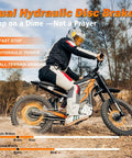 Rider on G300 Pro Electric Dirt Bike For Adults With 72V 30Ah Battery, 6500W Peak Power, demonstrating hydraulic brakes