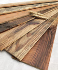Reclaimed Pine Wood Planks Peel And Stick Shiplap Panels arrayed on fabric with rustic barn wood look and wheat accent.