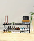 Expandable 45.6 Inch Metal Shoe Rack Organizer 2 Tier Stackable Boot Shelf That Holds Up To 18 Pairs in a bedroom setting.