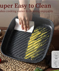 11 Inch Nonstick Grill Pan For Steak With Granite Coating being cleaned with paper towel, square grill skillet indoors, easy clean