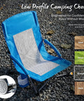 Low Profile Folding Beach Chair With Cup Holders And Carry Bag, Extra Wide Seat and mesh back, on gravel, blue color.