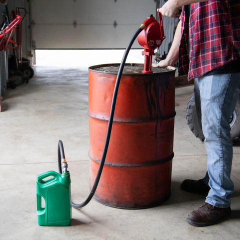 Manual Fuel Transfer Rotary Hand Pump With Reversible Flow No Power Needed, Grab-and-Go Portable Tool For Fueling Or Draining Vehicle Tanks, Discharge Hose, Straight Spout, Vacuum Breaker, Suction Pipe, Theft Prevention Design, red cast-aluminum drum pump transferring fuel to green container