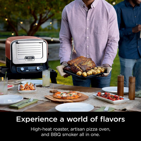 Woodfire Outdoor Pizza Oven 8 In 1 Portable Electric Roaster Heats Up To 700 Degrees Fahrenheit displayed on a patio table