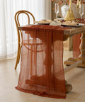 Rustic Fall Thanksgiving Table Runner Terracotta Cheesecloth Weave 120 Inches Long Hand Dyed Soft Cotton Gauze draped on dining table.