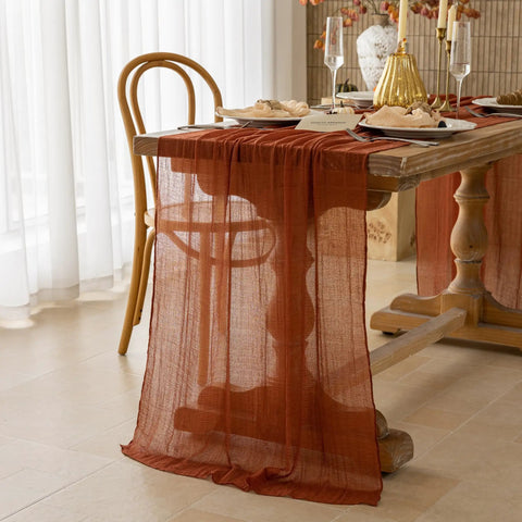 Rustic Fall Thanksgiving Table Runner Terracotta Cheesecloth Weave 120 Inches Long Hand Dyed Soft Cotton Gauze draped on dining table.