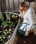 Woman using 2-In-1 Garden Kneeler And Seat With Cushioned Pad, Foldable Stool for Weeding And Planting near raised garden bed
