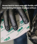 Gloved hand using Softback Sanding Sponge 4.5 x 5.5 Inches, 20 Pack, Microfine Grit, Flexible Foam Backing For Hand Sanding