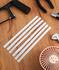Pro Grade Twenty Pack Reflective Tachometer Tape Strips For Optical And Laser Tachometers on a wooden table