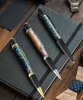 12 Pack Woodturning Pen Kit With Twist Ballpoint Refills Copper Turning Supplies on black notebook