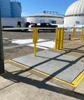 Heavy Duty Cantilever Dock Gate 12 Foot Wide Double Action Slick Pneumatic Struts OSHA compliant yellow barrier over loading bay.