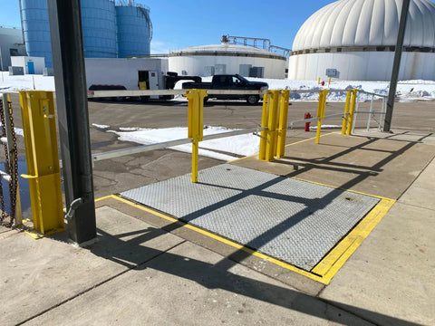 Heavy Duty Cantilever Dock Gate 12 Foot Wide Double Action Slick Pneumatic Struts OSHA compliant yellow barrier over loading bay.