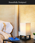 Maxwell Bedside Lamp With USB Port on nightstand, cozy wood frame, soft LED glow, bedroom setting with books and decor