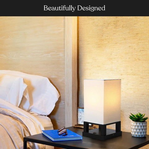 Maxwell Bedside Lamp With USB Port on nightstand, cozy wood frame, soft LED glow, bedroom setting with books and decor