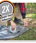 Person applying Heavy Duty Silver Duct Tape 1.88 Inch By 35 Yard Double Thick Adhesive With Reinforced Backing to outdoor tarp
